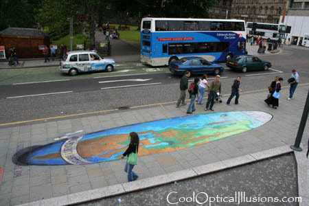 side view of sidewalk globe chalk painting
